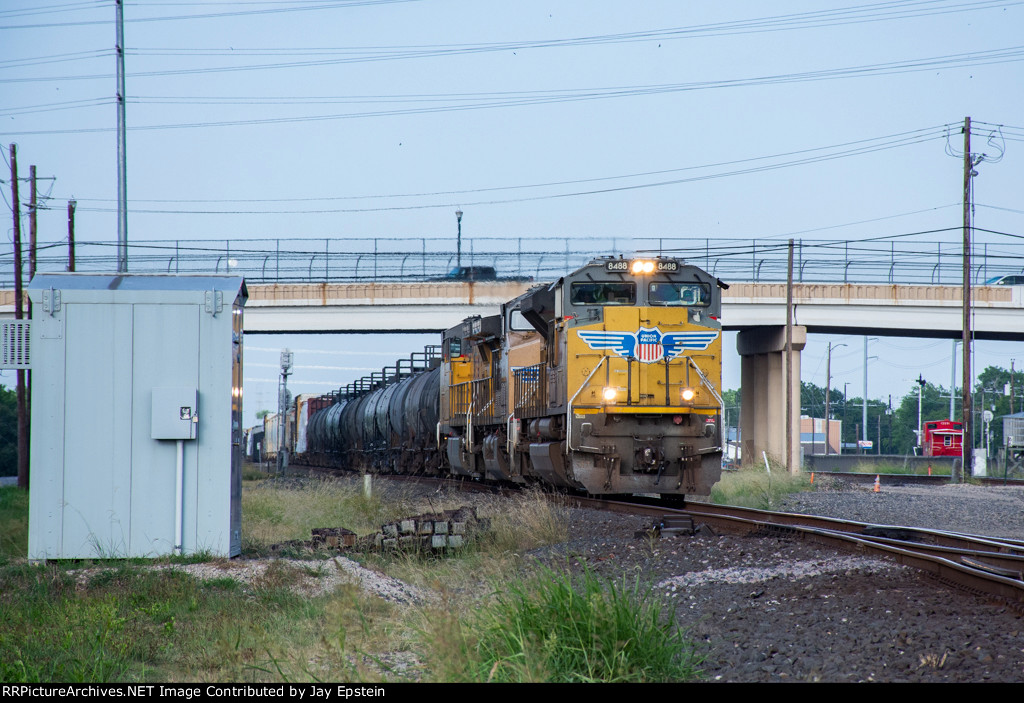 UP 8488 leads a manifest west under First Street. 